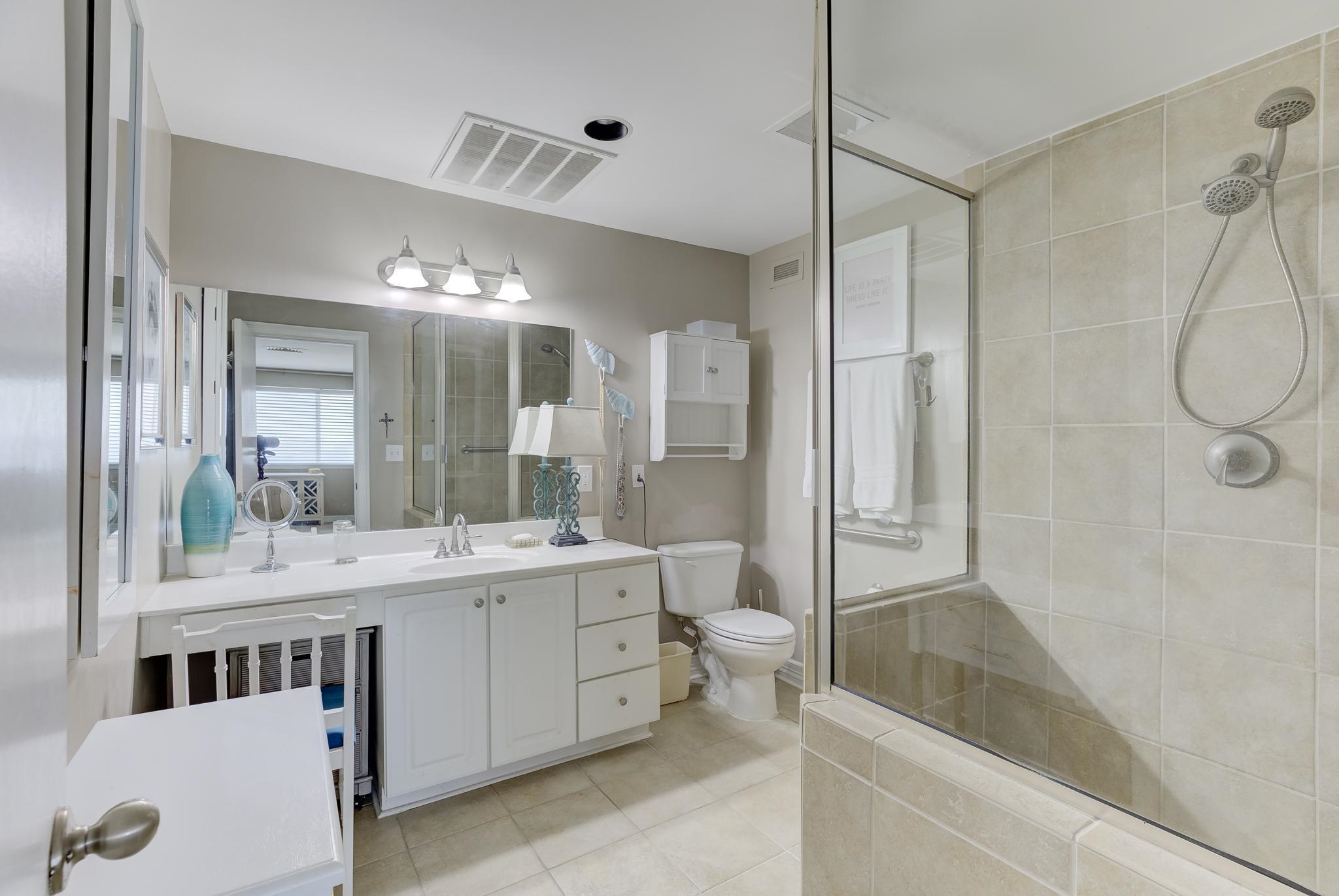 655 Riverside Drive, Unit 506B Memphis, TN 38103 - Photo 15 of 26 a bathroom with a double vanity sink toilet mirror and bathtub