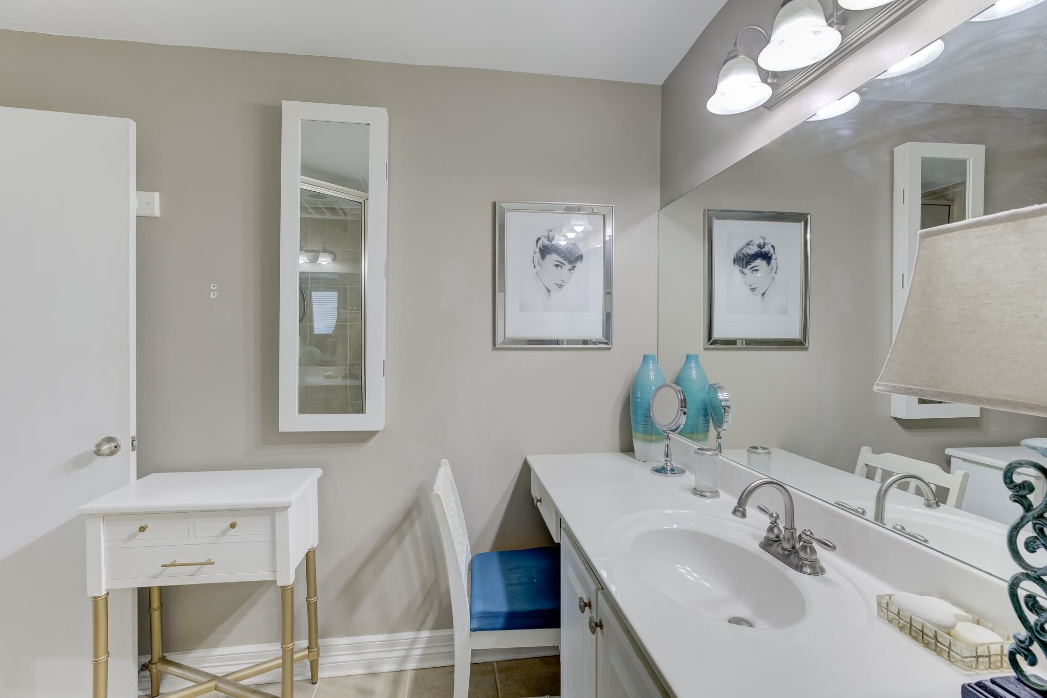 655 Riverside Drive, Unit 506B Memphis, TN 38103 - Photo 16 of 26 a bathroom with a sink and a mirror