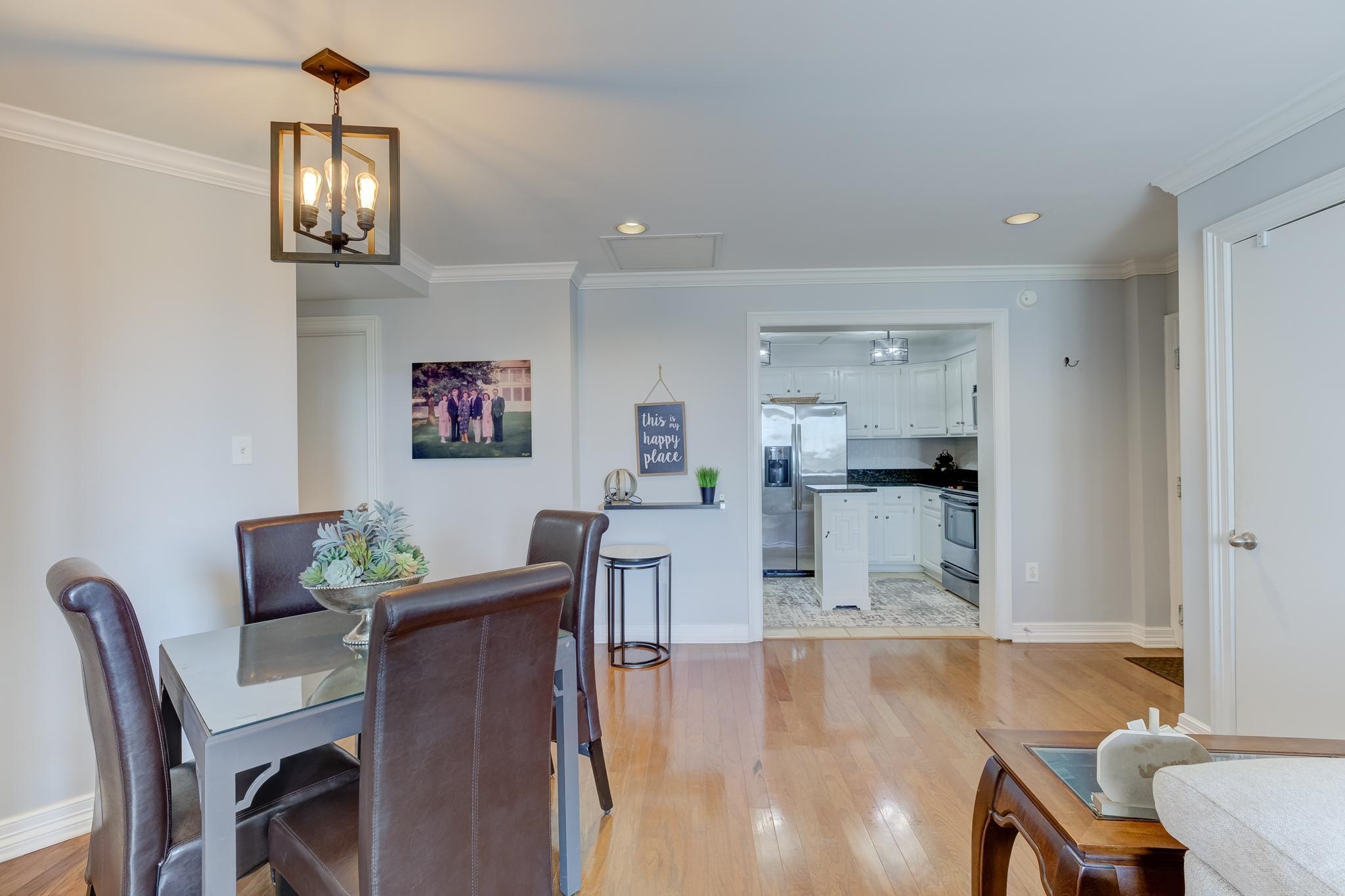 655 Riverside Drive, Unit 506B Memphis, TN 38103 - Photo 6 of 26 a view of a dining room with furniture and wooden floor