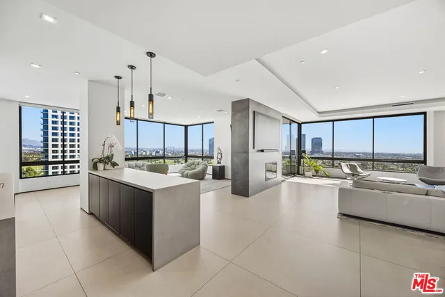 a large white kitchen with a large window and stainless steel appliances