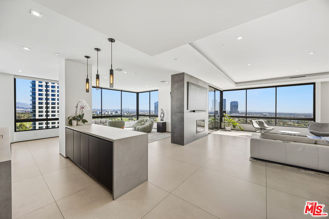 a large white kitchen with a large window and stainless steel appliances