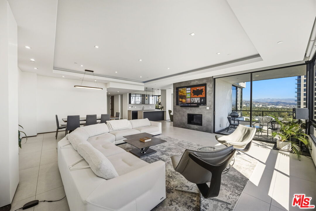 10350 Wilshire Boulevard, Unit 1203 Los Angeles, CA 90024 - Photo 15 of 69 a living room with furniture and a flat screen tv