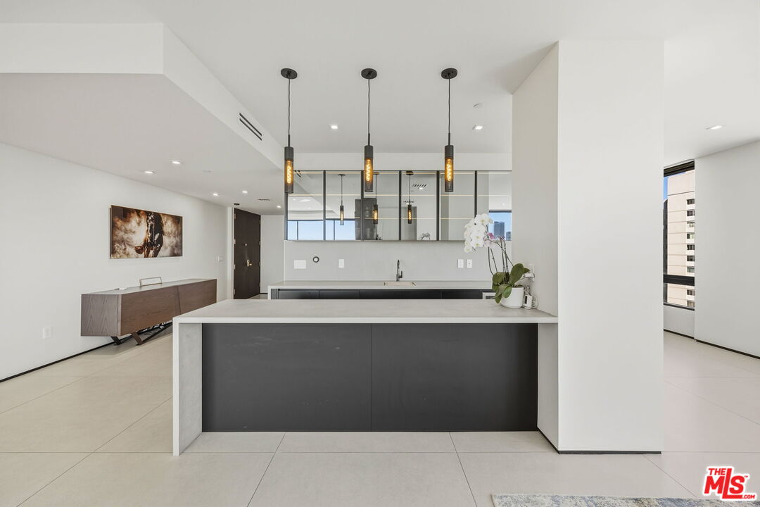 10350 Wilshire Boulevard, Unit 1203 Los Angeles, CA 90024 - Photo 16 of 69 a view of a kitchen with stainless steel appliances granite countertop a stove a refrigerator a sink and a refrigerator