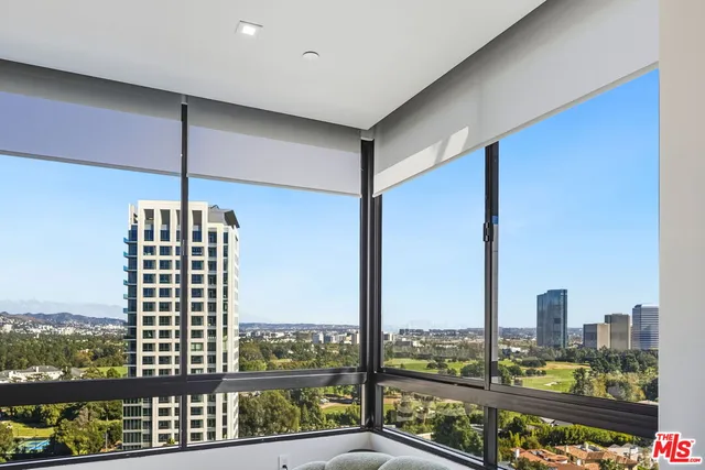 a large living room with a large window and a flat screen tv
