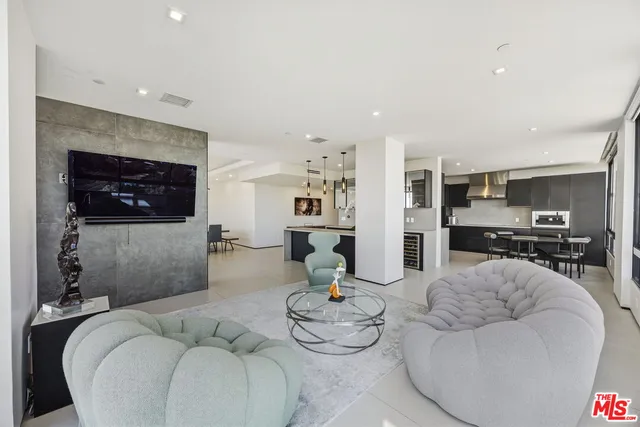 a kitchen with stainless steel appliances kitchen island a refrigerator sink and cabinets