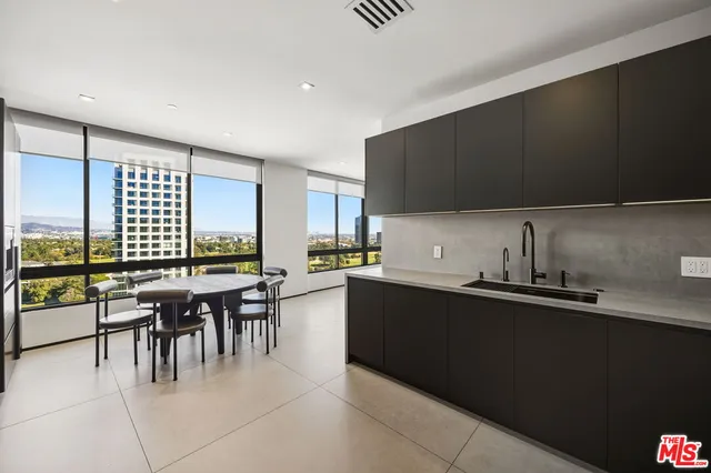 a bathroom with a tub sink vanity and mirror