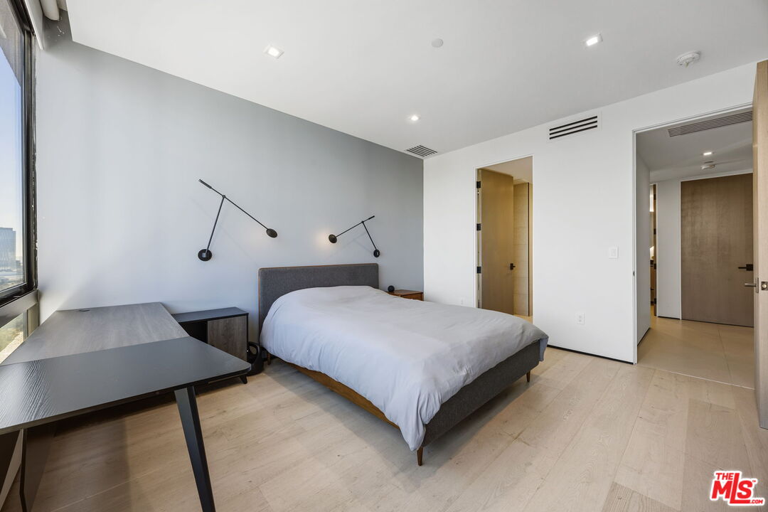 10350 Wilshire Boulevard, Unit 1203 Los Angeles, CA 90024 - Photo 29 of 69 a bedroom with a bed and a flat screen tv