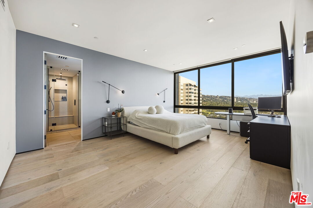 10350 Wilshire Boulevard, Unit 1203 Los Angeles, CA 90024 - Photo 33 of 69 a bed room with a bed and a large window