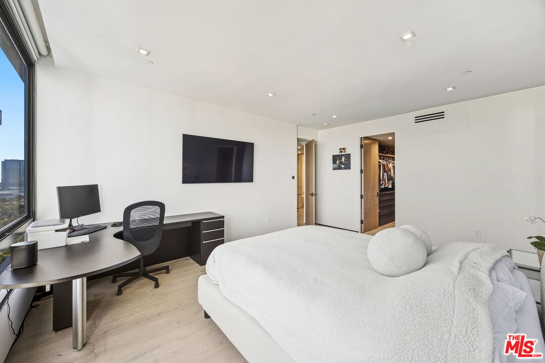 10350 Wilshire Boulevard, Unit 1203 Los Angeles, CA 90024 - Photo 34 of 69 a bedroom with a bed computer on desk and a chair