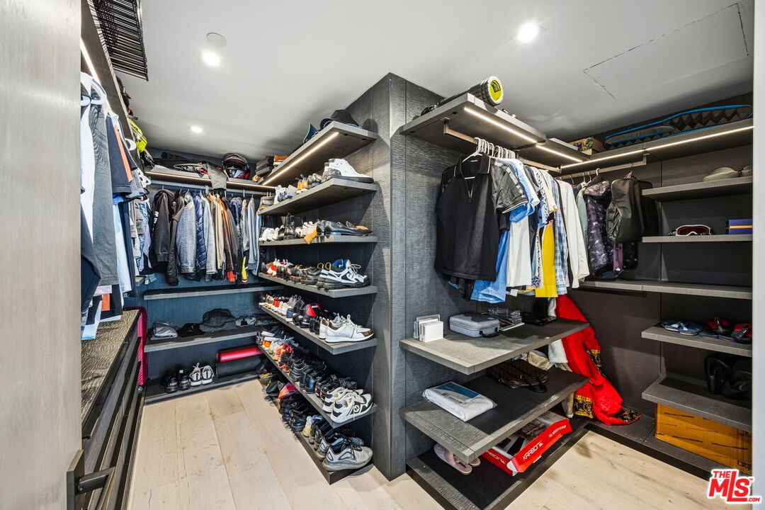 10350 Wilshire Boulevard, Unit 1203 Los Angeles, CA 90024 - Photo 38 of 69 a view of walk in closet with clothes and shoes