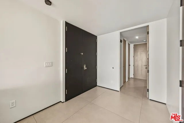 a view of kitchen with refrigerator and window