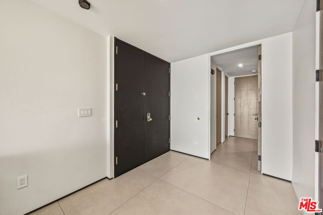 10350 Wilshire Boulevard, Unit 1203 Los Angeles, CA 90024 - Photo 4 of 69 a view of an empty room with closet and a bathroom