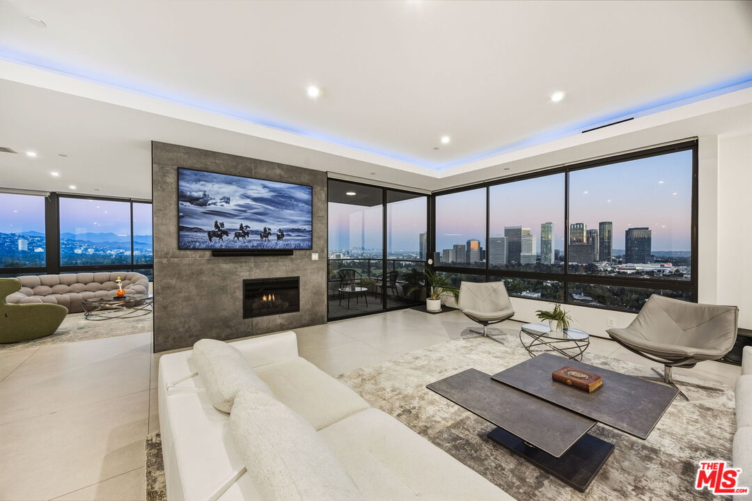 10350 Wilshire Boulevard, Unit 1203 Los Angeles, CA 90024 - Photo 41 of 69 a living room with fireplace furniture and a large window