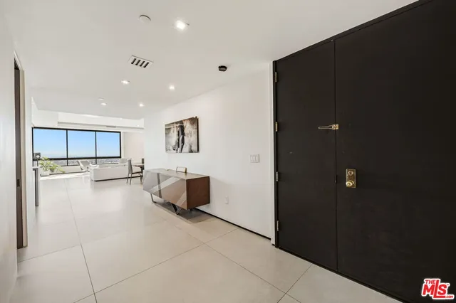 a large kitchen with a large counter top appliances and cabinets
