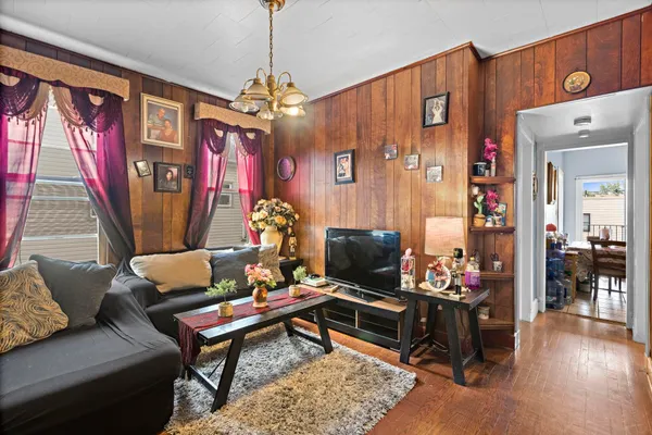 a living room with furniture and a chandelier