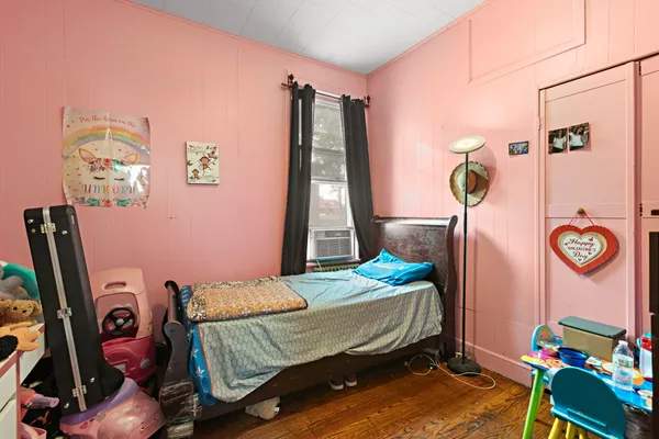 a bedroom with bed and a chandelier