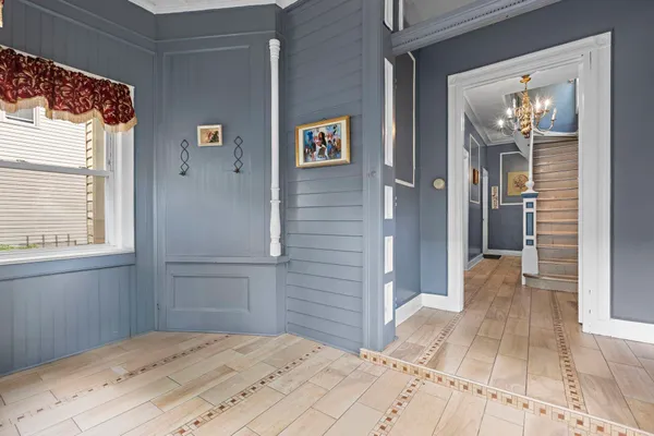 a view of a hallway with wooden walls and windows