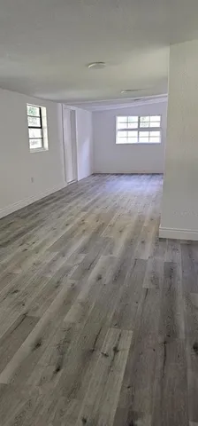 a view of wooden floor and windows in a room