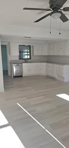 a view of a kitchen with a dishwasher and cabinets
