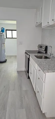 a utility room with cabinets washer and dryer
