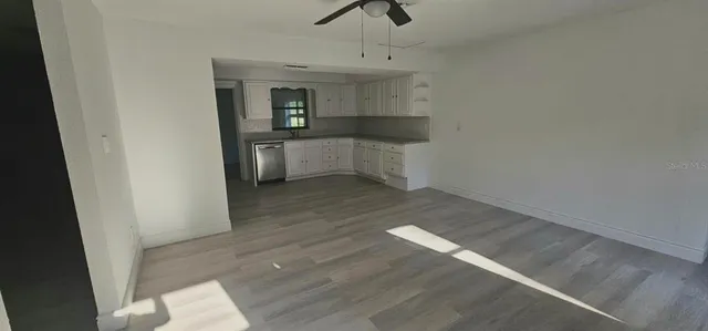 wooden floor in an empty room and a kitchen