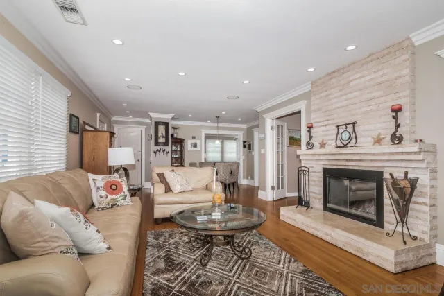 a living room with furniture a fireplace and a table