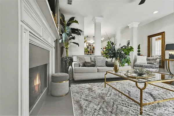 a living room with furniture and a potted plant