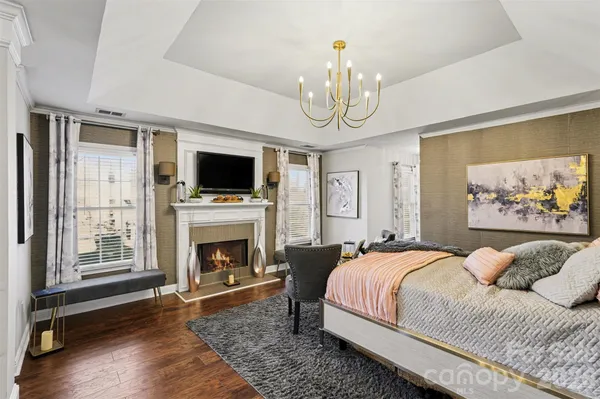 a spacious bedroom with a bed and a fireplace