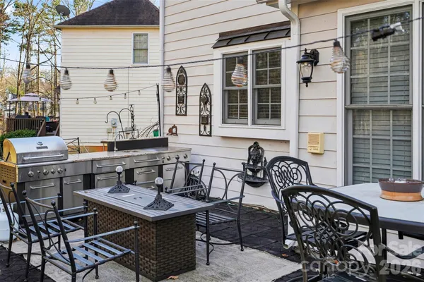 a table and chairs sitting in front of a house