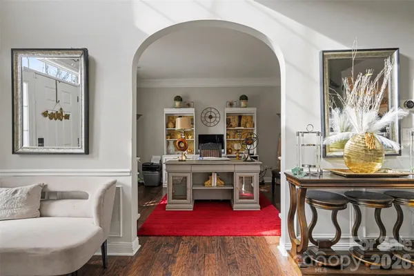 a living room with furniture and paintings on the wall