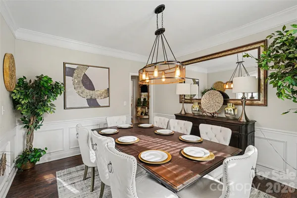 a dining room with furniture and wooden floor