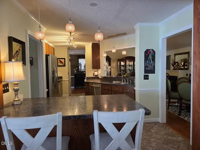 a view of a dining room with furniture and chandelier