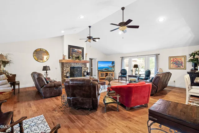 a living room with furniture a ceiling fan and a rug