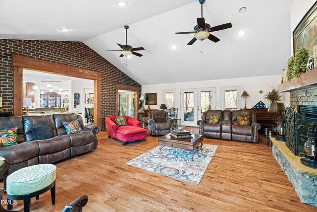 a living room with furniture kitchen view and a large window