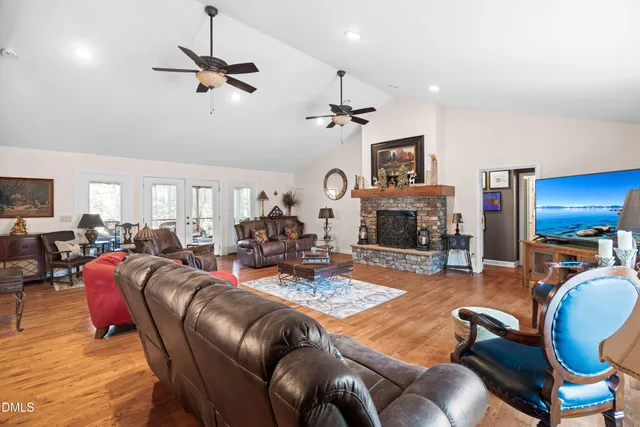 a living room with furniture a fireplace and a flat screen tv