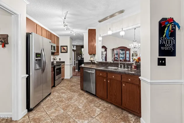 a large kitchen with kitchen island granite countertop a sink and cabinets