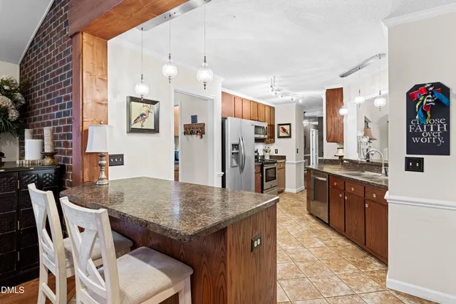 a kitchen with stainless steel appliances granite countertop a refrigerator and a sink