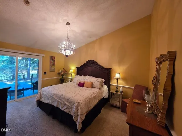 a bedroom with a bed dresser and a window