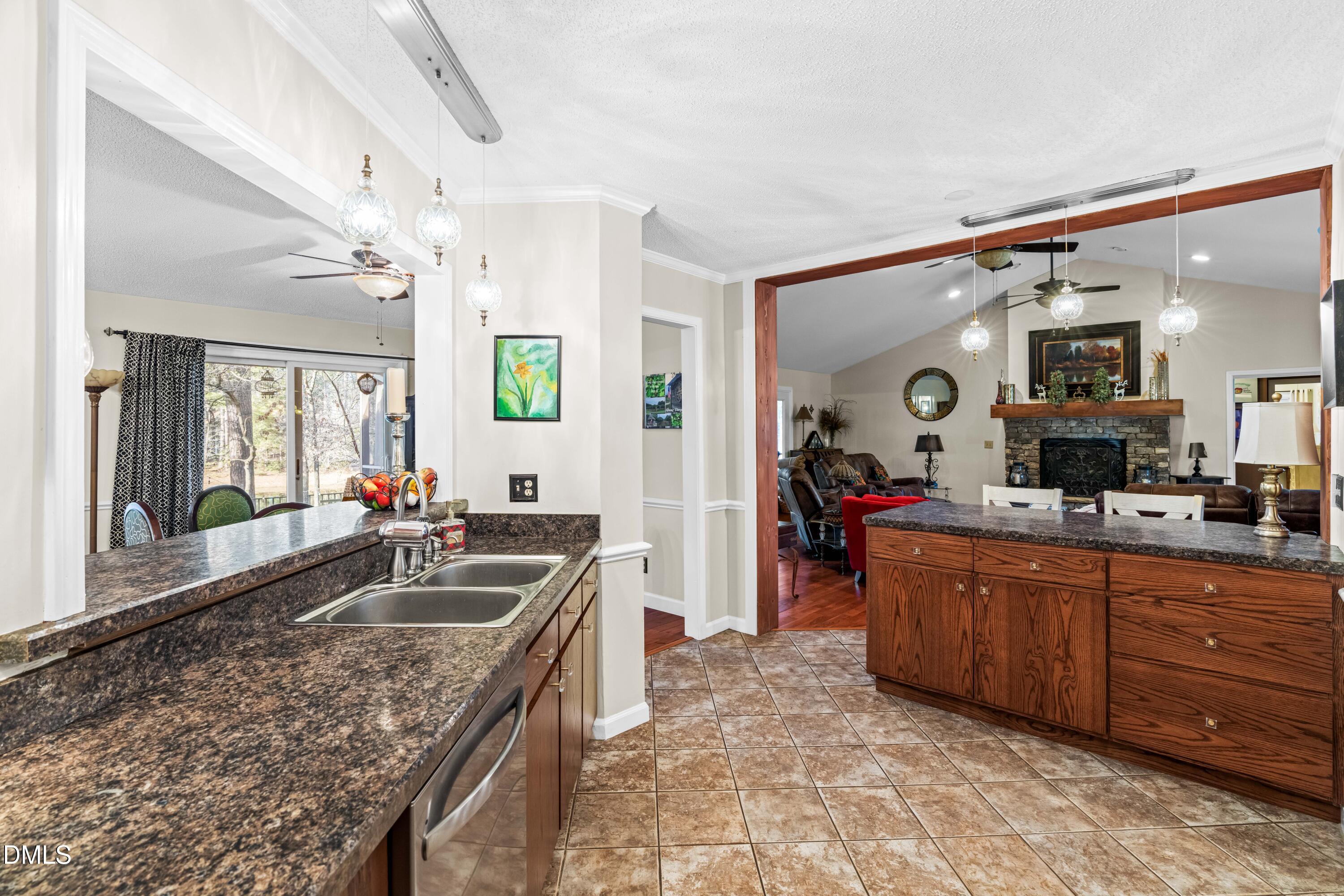 335 Sprunt Drive Clinton, NC 28328 - Photo 22 of 52 a large kitchen with kitchen island granite countertop a sink and cabinets