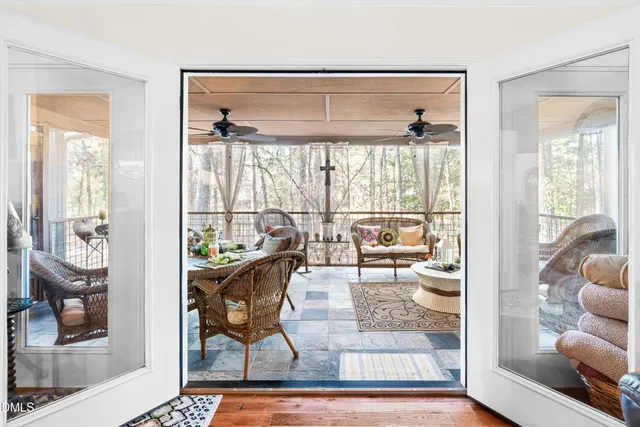 a spacious bedroom with a bed chandelier and a window
