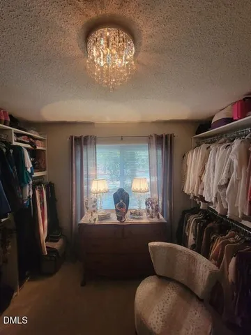 a living room with furniture a flat screen tv and a window