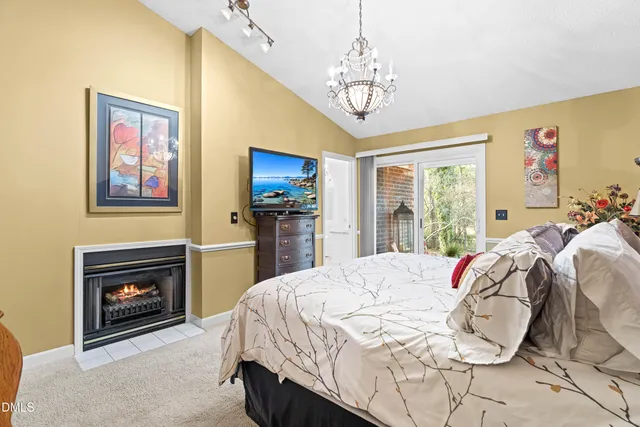 a spacious bedroom with a bed and a chandelier