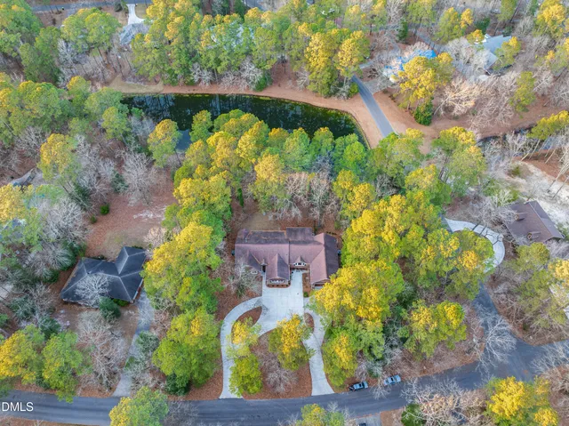 a dining room with furniture a chandelier and wooden floor