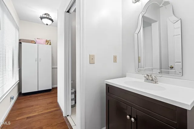 a bathroom with a sink a toilet and a mirror