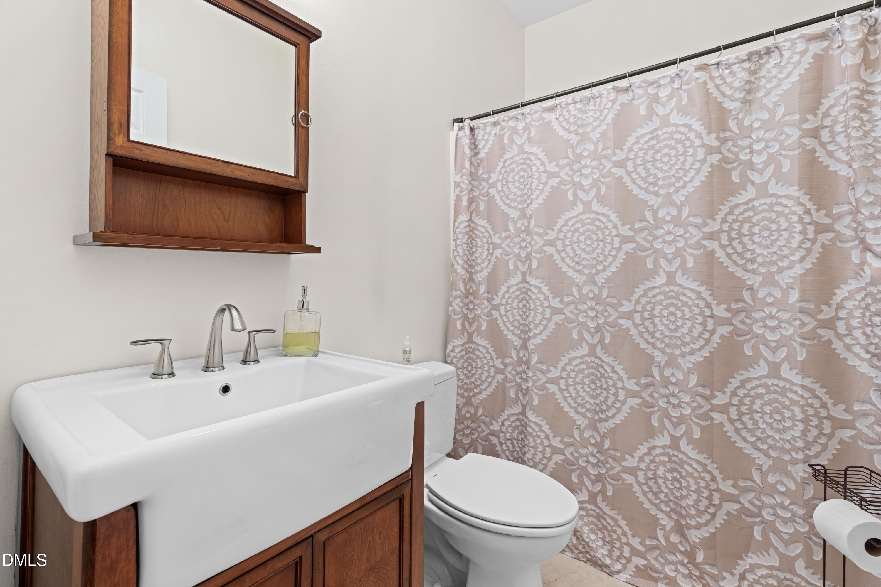 335 Sprunt Drive Clinton, NC 28328 - Photo 38 of 52 a bathroom with a sink a toilet and a mirror