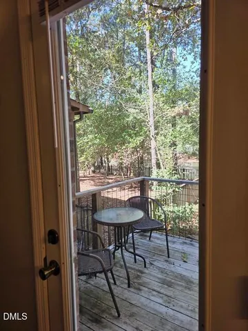 a view of a room with a table and chairs