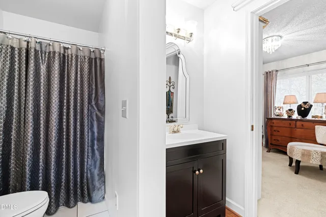 a view of a patio with chairs and a table and chairs with wooden fence