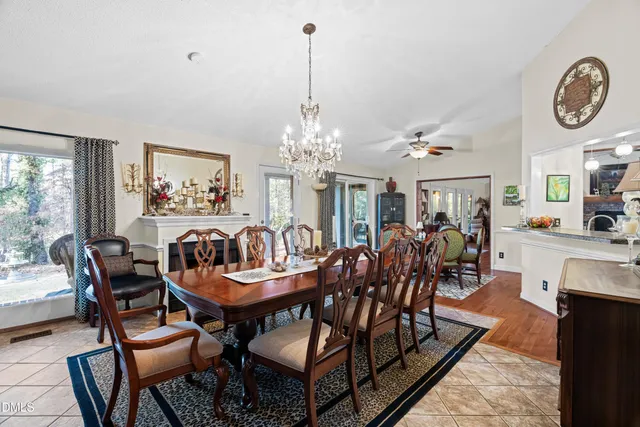 a view of a dining room with furniture a chandelier and wooden floor