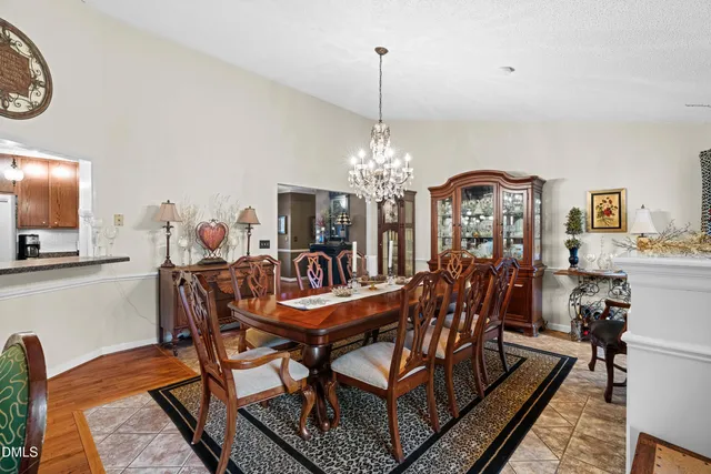 a dining room with furniture a chandelier and a rug