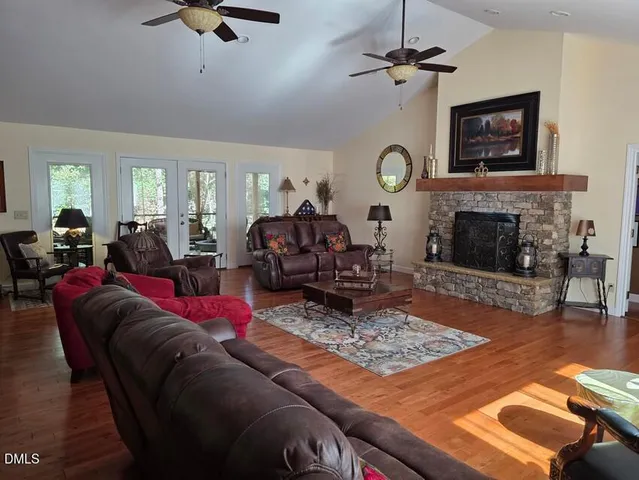 a living room with furniture fireplace and window